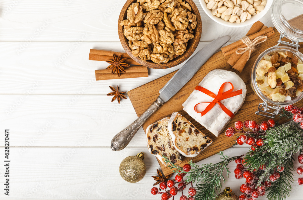 Christmas stollen on wooden background. Traditional Christmas festive pastry dessert. Holiday concept. Dessert, cake, pie with marzipan, nuts and dried fruits. Stollen for Christmas. Spicy pastries. Christmas stollen on wooden background. Traditional Christmas festive pastry dessert. Holiday concept. Dessert, cake, pie with marzipan, nuts and dried fruits. Stollen for Christmas. Spicy pastries.
