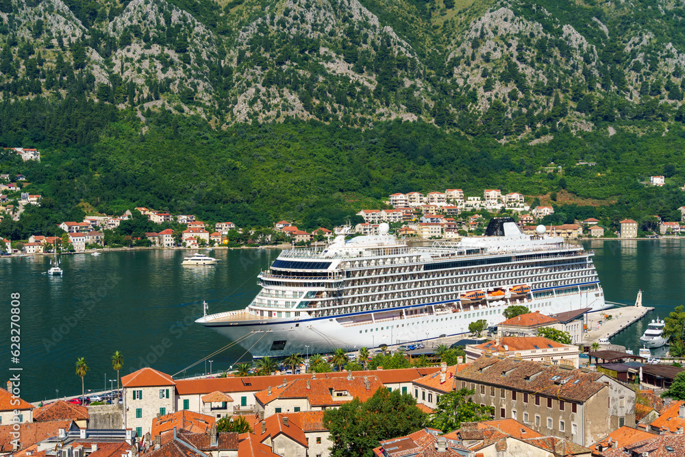 view of the old town of Kotor in Montenegro and the coast of the Bay of Kotor, the sea and medieval European architecture, red tiled roofs, the concept of traveling across the Balkans