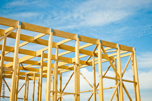 construction of a building made of wood in the background blue sky