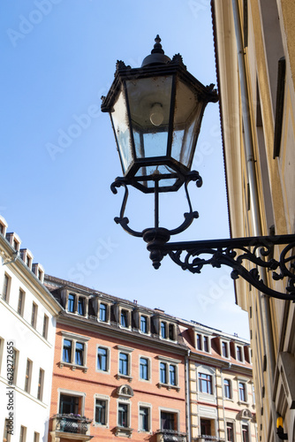 View of a beautiful street lamp against a blue sky. City landscape, vertical view