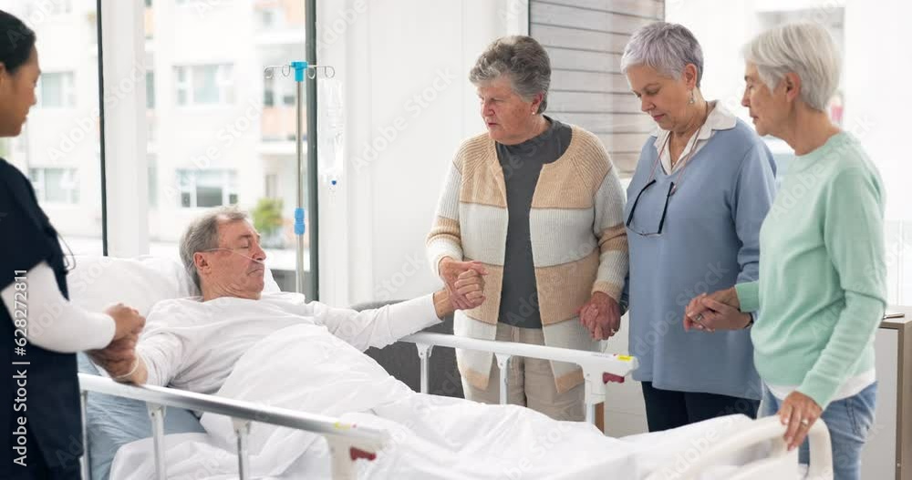 Hospital, praying and friends visit man for comfort, care and support for wellness, service and surgery. Healthcare, medical clinic and women with patient for recovery, rehabilitation and prayer Hospital, praying and friends visit man for comfort, care and support for wellness, service and surgery. Healthcare, medical clinic and women with patient for recovery, rehabilitation and prayer