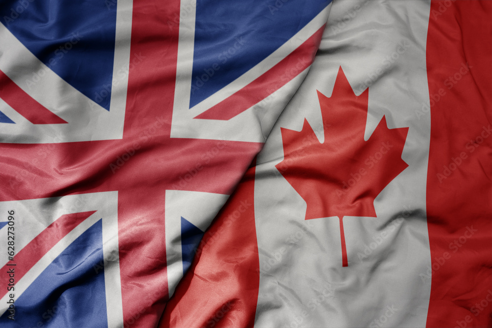 Fototapeta premium big waving national colorful flag of great britain and national flag of canada .