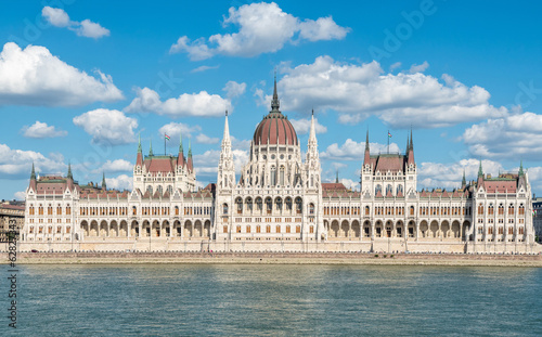 Hungarian Parliament building in Budapest, Hungary. View across Danube River, with summer clouds.