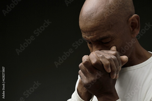 man praying to god with hands together worshiping God Caribbean man praying stock image stock photo 