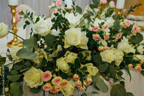 Beautiful tenderless bouquet on wedding table. Elegance wedding decor. photo