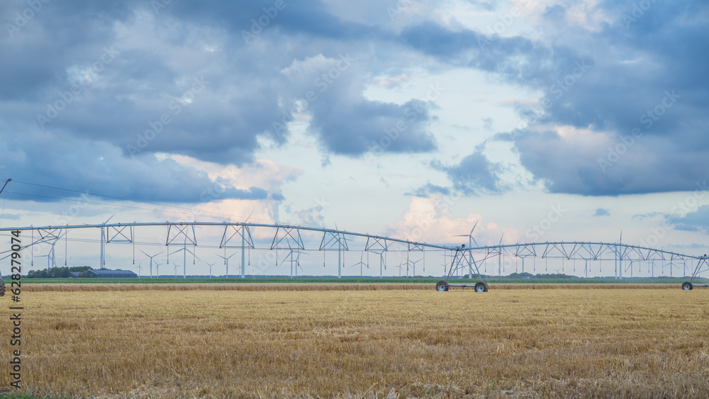 irrigation system with wind turbine in the farmland in Netherlands irrigation system with wind turbine in the farmland in Netherlands