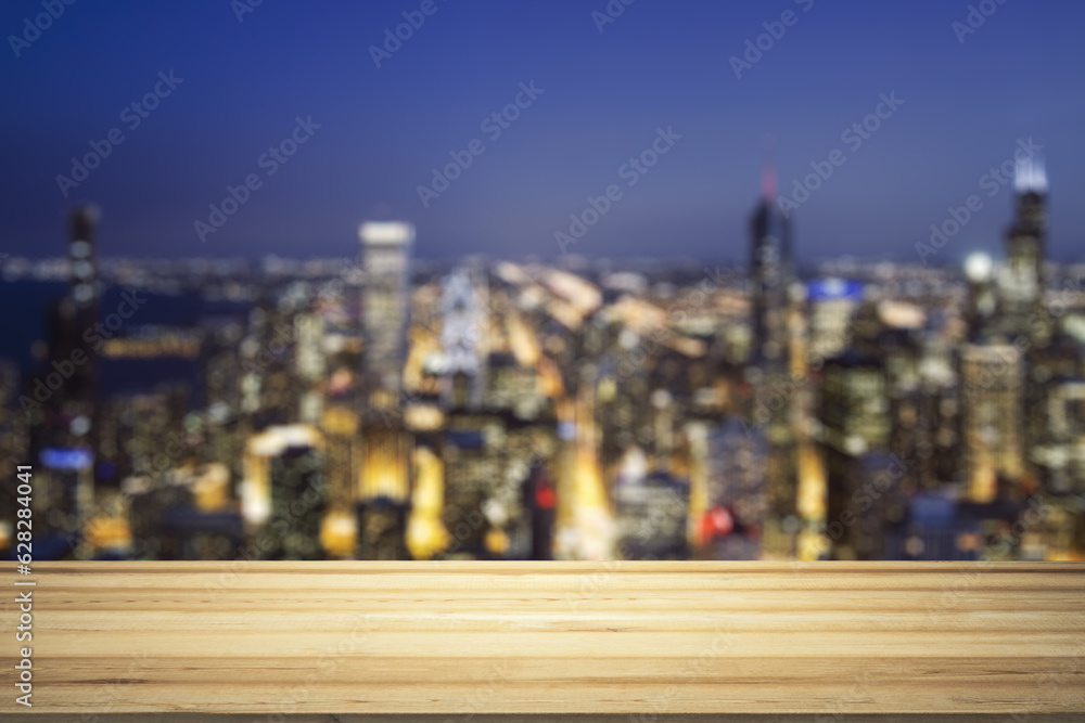 Empty wooden table top with beautiful blurry skyscrapers at evening on background, mock up Empty wooden table top with beautiful blurry skyscrapers at evening on background, mock up