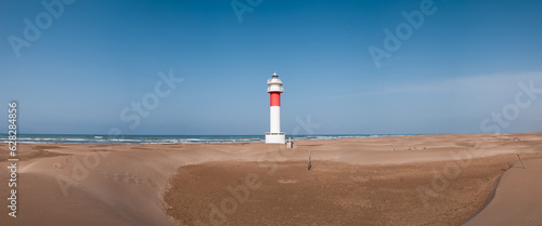 panorama of lighthouse on a sunny day in Punta del Fangar. Ebro Delta.