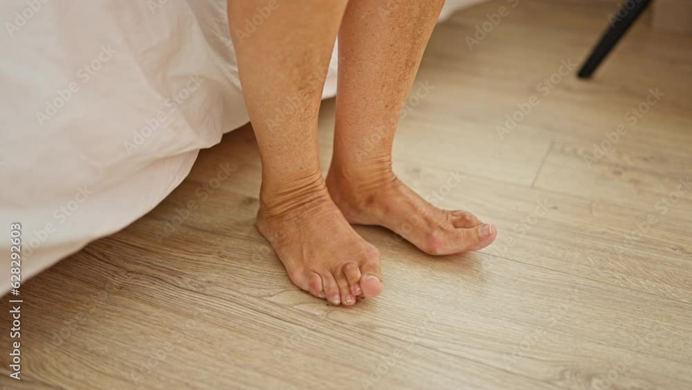 Middle age hispanic woman stand up of bed at bedroom Middle age hispanic woman stand up of bed at bedroom