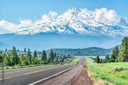 Long road leading towards Mt Shasta in the Cascade mountains in the Klamath National Forest of California