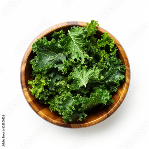Top-down view of a bowl of kale chips isolated on a white background