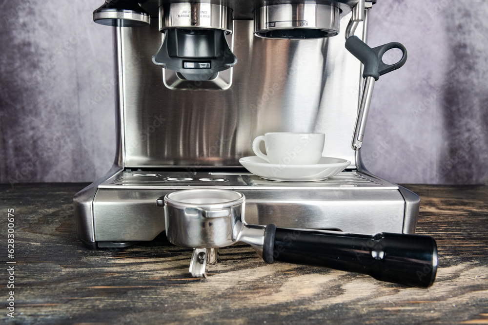 Modern steel Espresso Coffee Maker against gray wall closeup Modern steel Espresso Coffee Maker against gray wall closeup