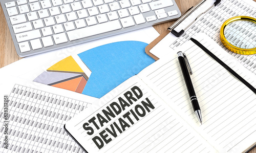 Konstfotografi STANDARD DEVIATION text on notebook with chart and keyboard