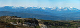 Panorama over nordic mountain peaks in Norway from a hike up Hauknestinden, Hauknes, Mo i Rana, Helgeland, Norway. Peaks in a fjord landscape, snow covered. Clear Norwegian summer skies. Wild Norway