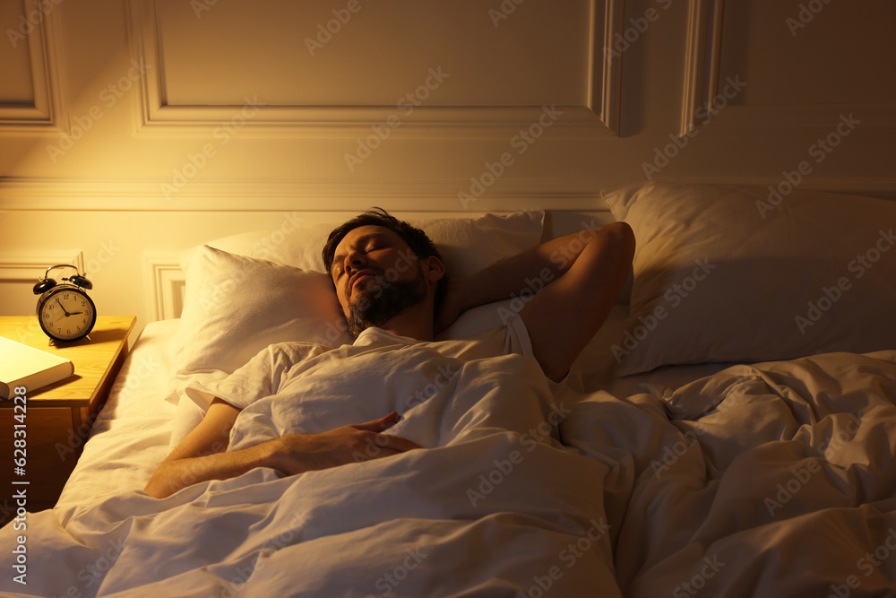 Handsome man sleeping in bed at night Handsome man sleeping in bed at night