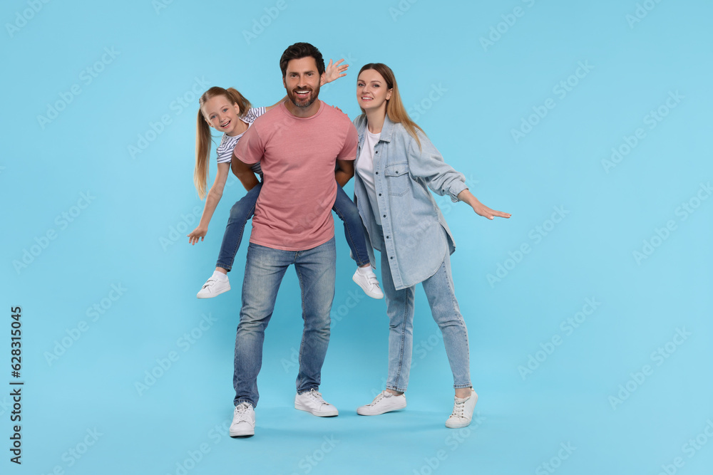 Obraz premium Happy family together on light blue background