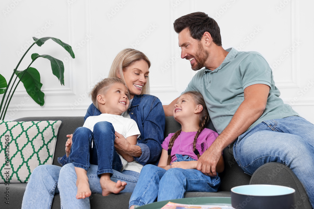 Happy family having fun together on sofa at home Happy family having fun together on sofa at home