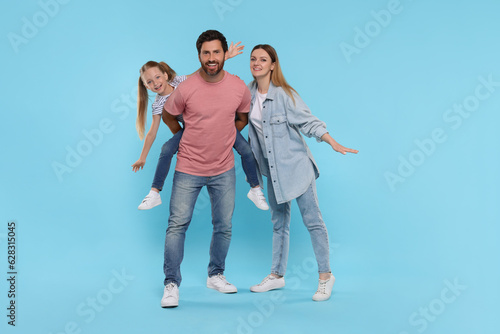 Happy family together on light blue background © New Africa