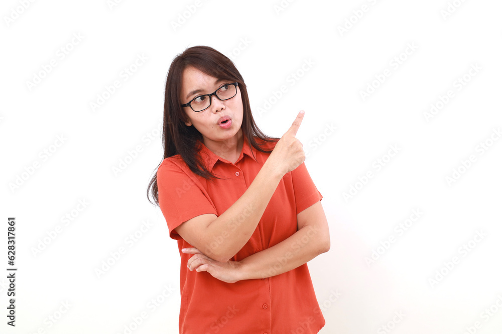 Wow expression of young asian woman standing while pointing sideways Wow expression of young asian woman standing while pointing sideways