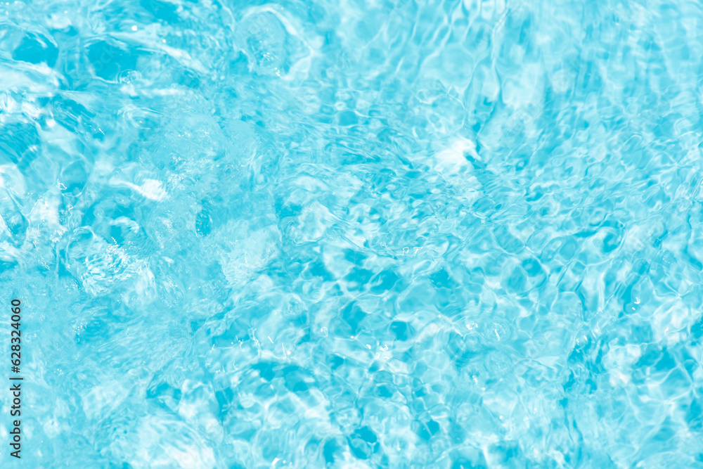 Blue water with ripples on the surface. Defocus blurred transparent blue colored clear calm water surface texture with splashes and bubbles. Water waves with shining pattern texture background. Blue water with ripples on the surface. Defocus blurred transparent blue colored clear calm water surface texture with splashes and bubbles. Water waves with shining pattern texture background.