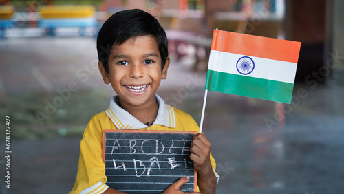 Portrait of Cute India Child or Kids celebrating Independence or Republic day of India photo