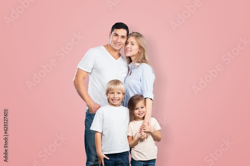 Young parents with child posing together on background