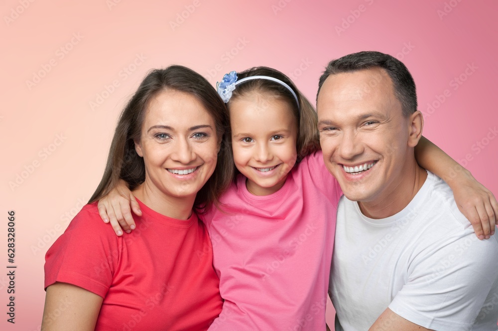 Young parents with child posing together on background Young parents with child posing together on background