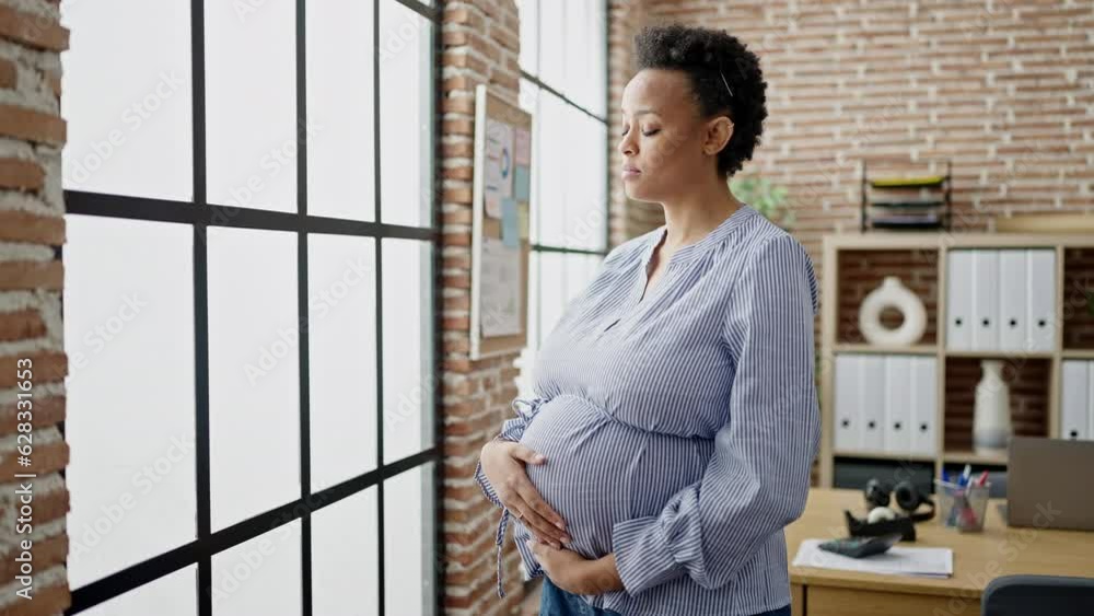 Young pregnant woman business worker smiling confident touching belly at office Young pregnant woman business worker smiling confident touching belly at office