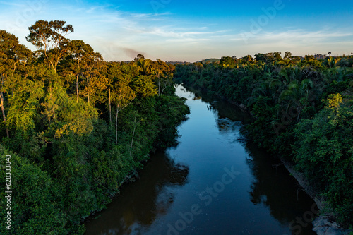 sunset over the small river on Amazon rainforest
