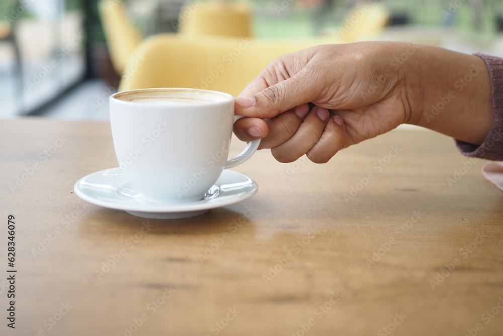 women holding a coffee cup women holding a coffee cup
