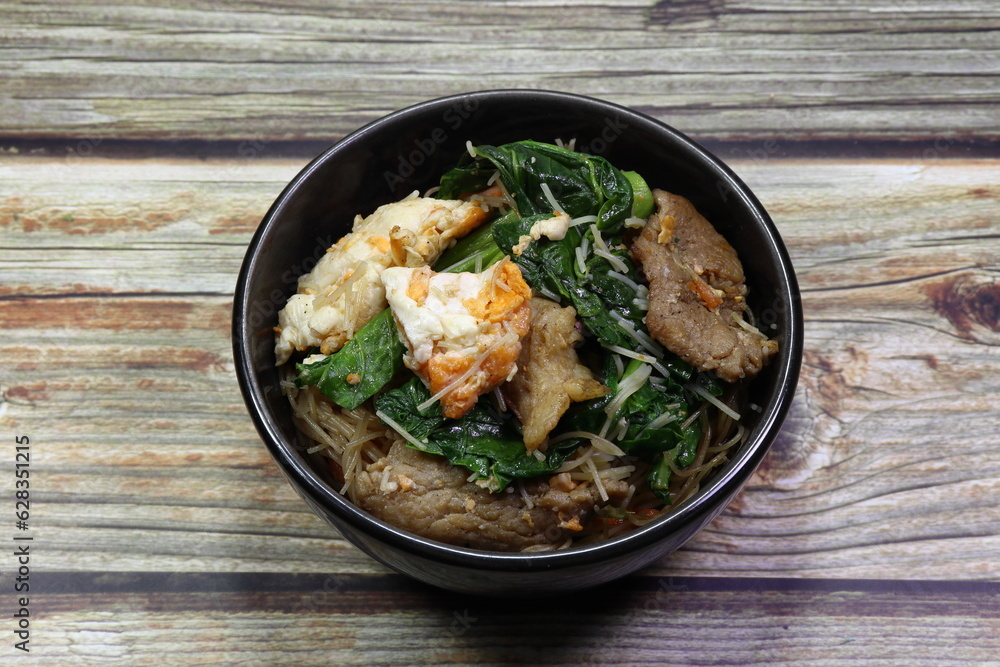 Traditional fried and stirred rice noodle with chicken egg, Chinese kale and pork seasoning with special sauce serving in the small bowl. Famous street food in Chinese restaurant. Traditional fried and stirred rice noodle with chicken egg, Chinese kale and pork seasoning with special sauce serving in the small bowl. Famous street food in Chinese restaurant.