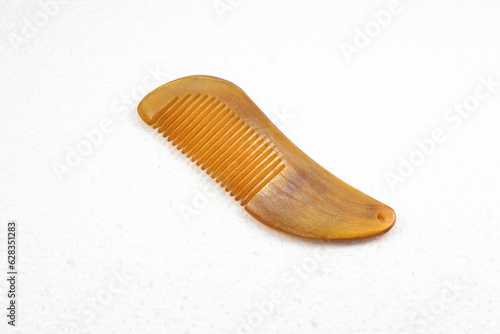 Gua sha or Skin scraping wooden comb isolated on the white background. Famous massage accessory in Asia.