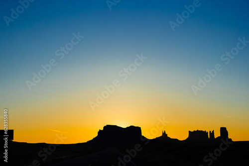 View of Monument Valley in Utah in moonlight. Sunset at Monument Valley with moon on the sky