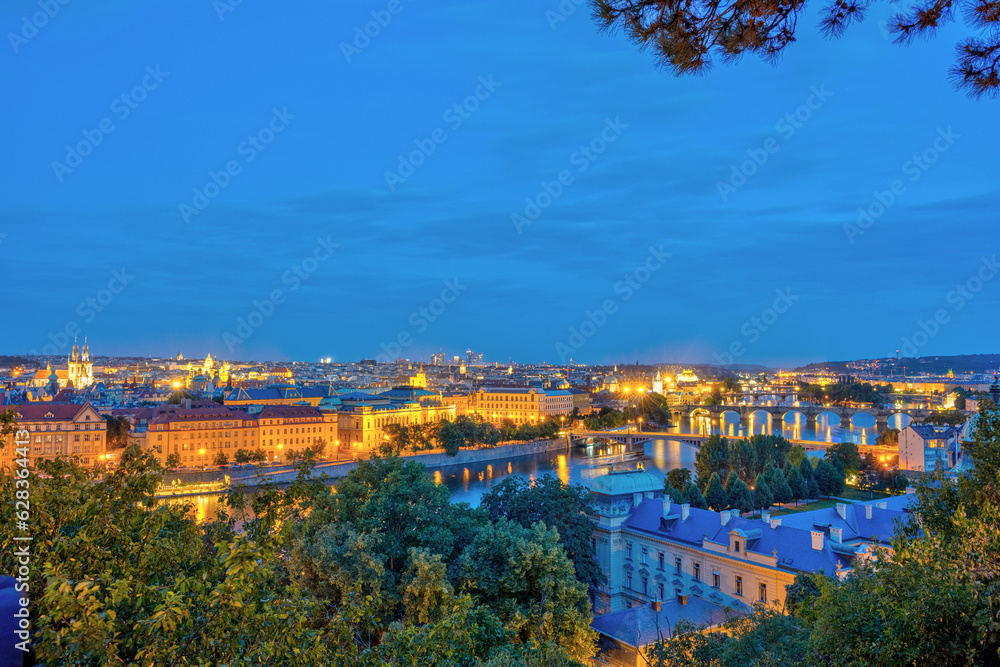 View over Prague with the river Vltava and the Charles Bridge at night