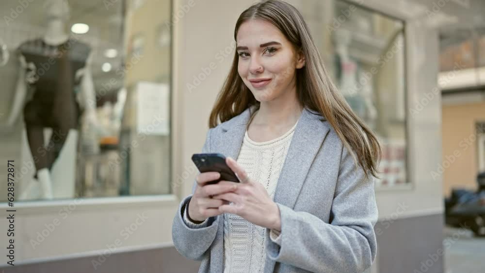 Young hispanic woman using smartphone smiling at street Young hispanic woman using smartphone smiling at street