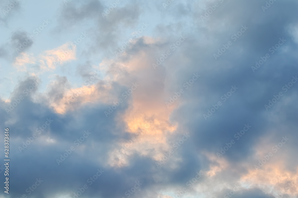 Cloudy sky background with golden clouds at sunset