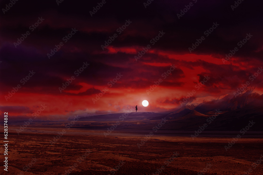 Lonely man stands alone beside the moon in a red landscape