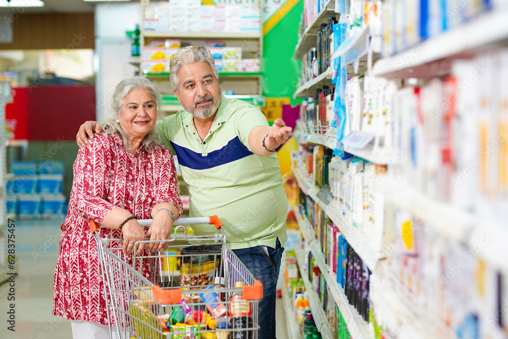 Indian senior couple shopping together at grocery shop.