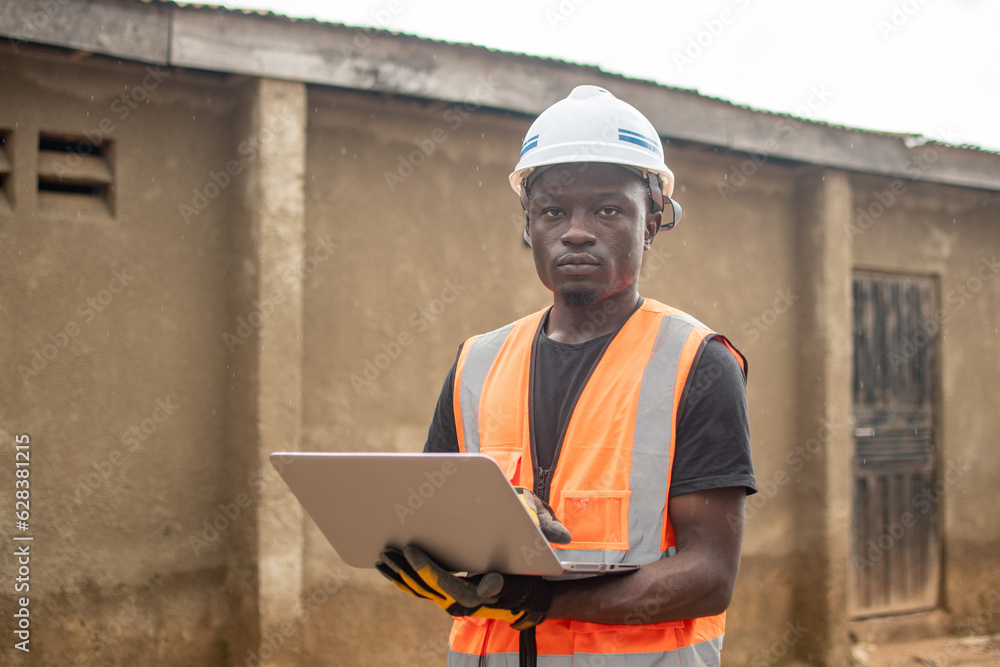 african engineer using his laptop computer african engineer using his laptop computer