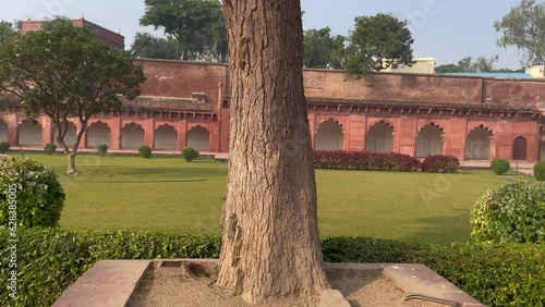 Agra India - December  07, 2022. Historical Fort of Agra, India, Panning view of the high sandstone walls - a UNESCO world heritage site. photo