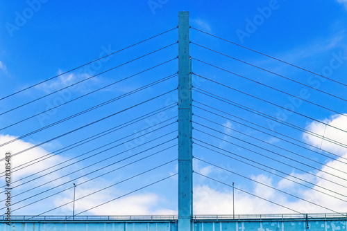 Fotografie, Obraz Road bridge pylon with cables at a blue sky