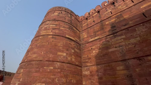 Agra India - December  07, 2022. Historical Fort of Agra, India, Panning view of the high sandstone walls - a UNESCO world heritage site. photo