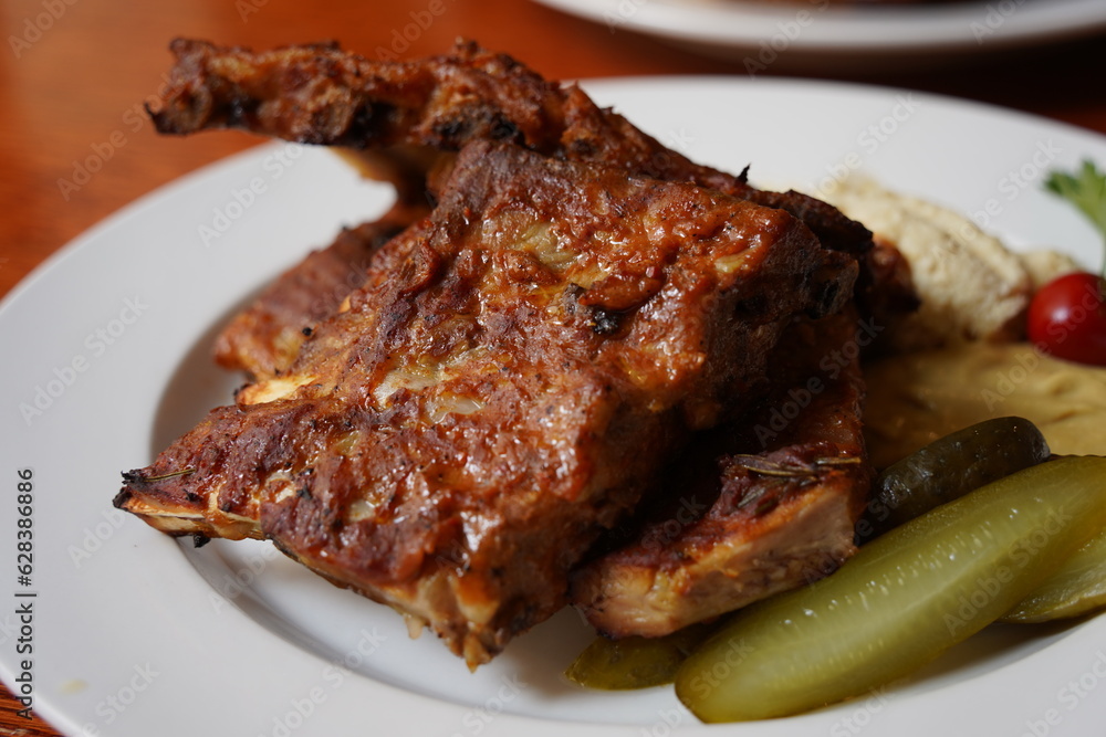 Ribs in spicy marinade with chili, honey, sour cabbage, pickle cucumber and mustard