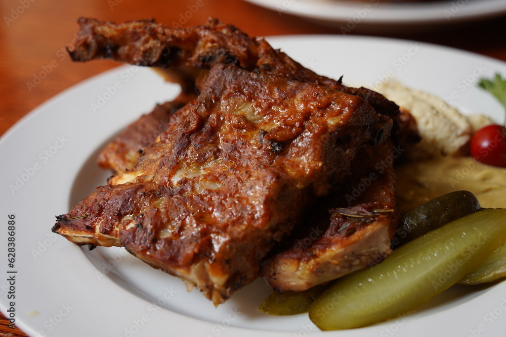 Ribs in spicy marinade with chili, honey, sour cabbage, pickle cucumber and mustard Ribs in spicy marinade with chili, honey, sour cabbage, pickle cucumber and mustard