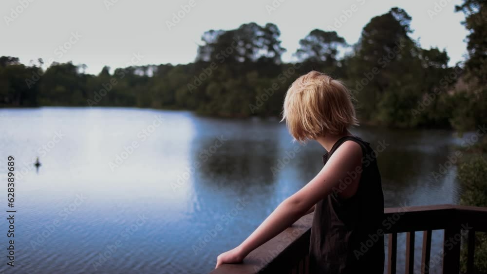 handsome teenage boy enjoying the view on the lake. getaway destination handsome teenage boy enjoying the view on the lake. getaway destination