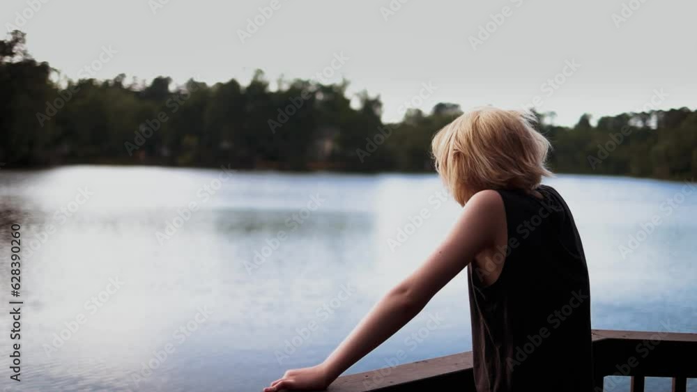 handsome teenage boy enjoying the view on the lake. getaway destination handsome teenage boy enjoying the view on the lake. getaway destination