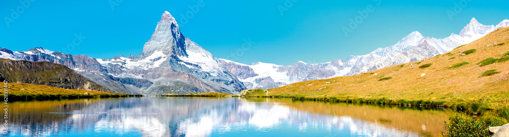 Matterhorn mountains snow sunn water lake