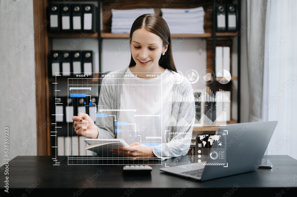 Business woman hand Project manager working and update tasks and Gantt chart scheduling virtual diagram.with smart phone, tablet and laptop in office. Business woman hand Project manager working and update tasks and Gantt chart scheduling virtual diagram.with smart phone, tablet and laptop in office.