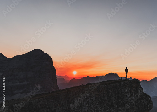 Silhouette of a person during a morning sunrise in the mountains of Italy