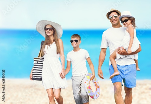 Happy young family walking at beach